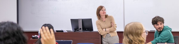Professor Megan Winchell in front of a class of students.