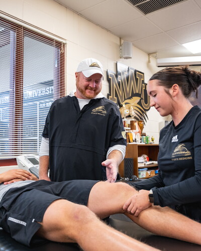 Jason Ensrud works with two NWU students.