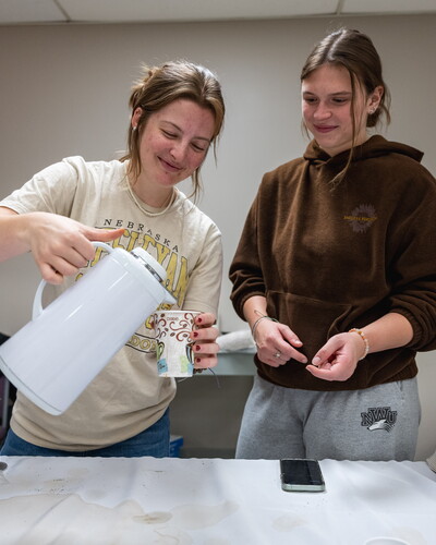 NWU students pour a cup of coffee.