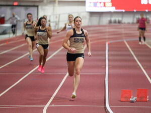 Bella Hogue runs on a track. 