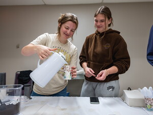 NWU students pour a cup of coffee.