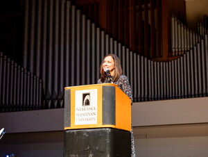 Carol Spahn, director of the US Peace Corps, gives remarks at podium.