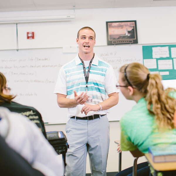 Male student teacher in front of a class