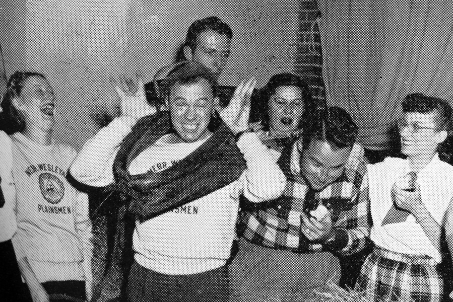 Students from 1940 laughing and acting silly in this old yearbook photo.