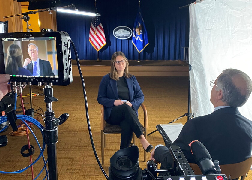 NWU student conducts video interview with State Department employee.