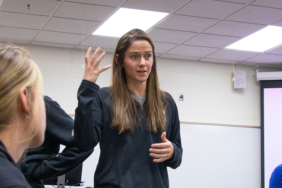 Professor Sam Wilson teaches in front of students in a classroom.