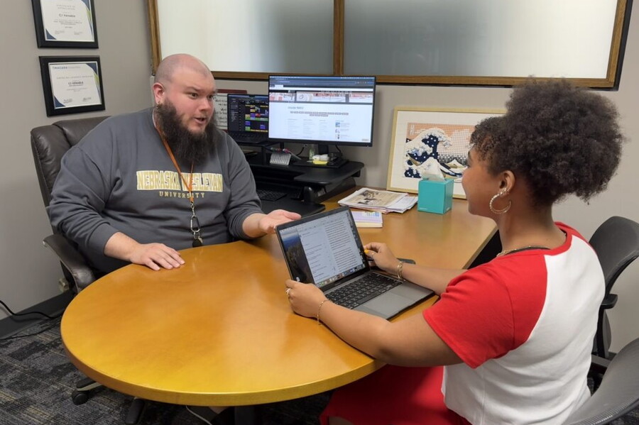 The NWU advising director in his office helping a student with her schedule.