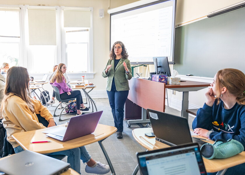 Sarah Kelen teaching in a classroom full of students.