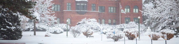 Snowy scene in front of the Old Main building.