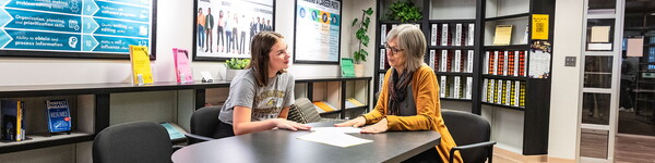 Janelle Andreini sits across from a female student in the Career Center.