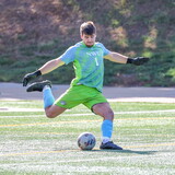 Zach Weis kicks a soccer ball during a NWU soccer game. 